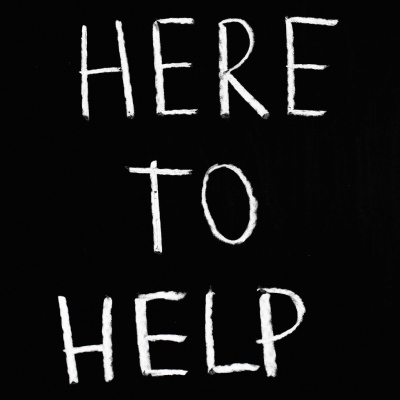 Blackboard with white lettering stating here to help. Do you need help with your legal billing costings?